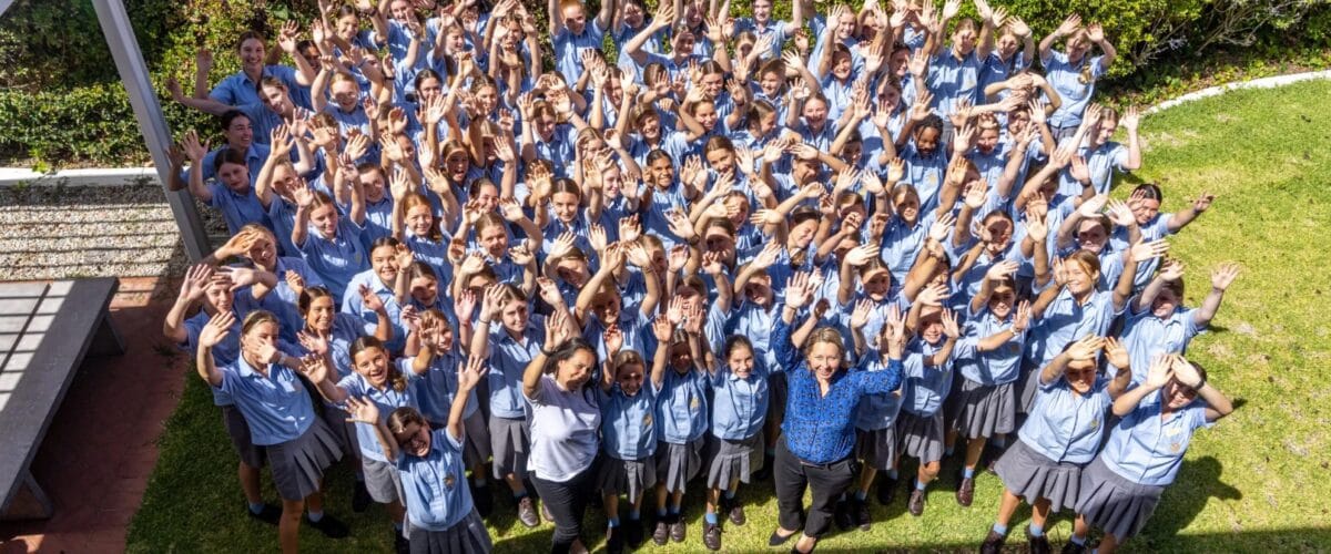 Group of St Hilda’s boarders and staff gathered outdoors, building connection at a leading female boarding schools provider