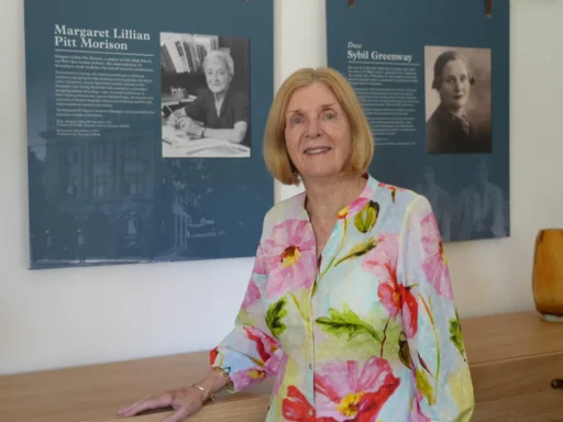 Woman standing in front of an archive photo wall