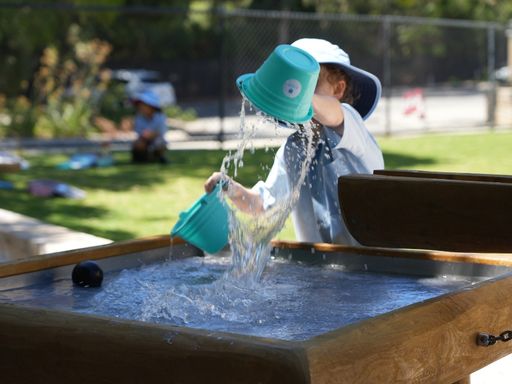 Student engaging in water play