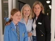 f_2_34490096 - St Hilda's Anglican School For Girls Three people posing for a photo: a student in a blue blazer and tie beside two adults in business attire, smiling at the camera.